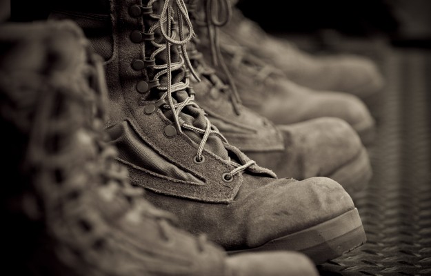 row of brown lace-up military boots